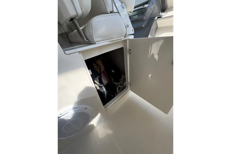 Slide: The Image of Storage compartment on a 2009 Monterey 320 Sport Yacht, featuring a clean, white interior. - 28