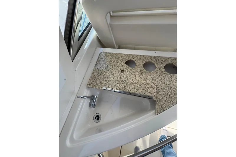 Slide: The Image of Open refrigerator inside 2009 Monterey 320 Sport Yacht, showcasing interior shelving. - 33
