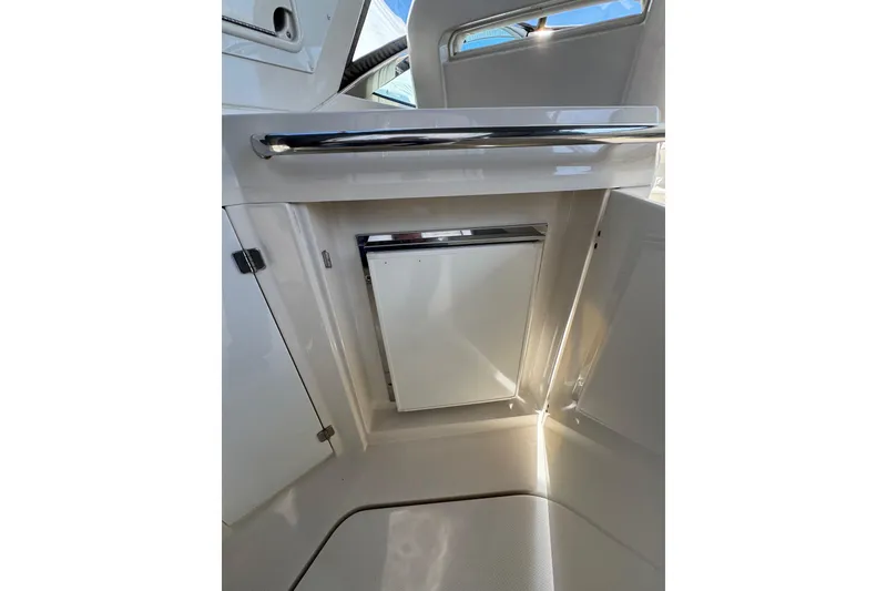 Slide: The Image of Cockpit view of a 2009 Monterey 320 Sport Yacht with steering wheel and navigation controls. - 35