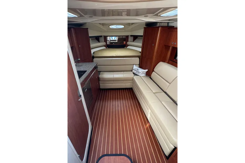 Slide: The Image of Luxurious interior of 2009 Monterey 320 Sport Yacht with beige leather seating and wooden cabinetry. - 43