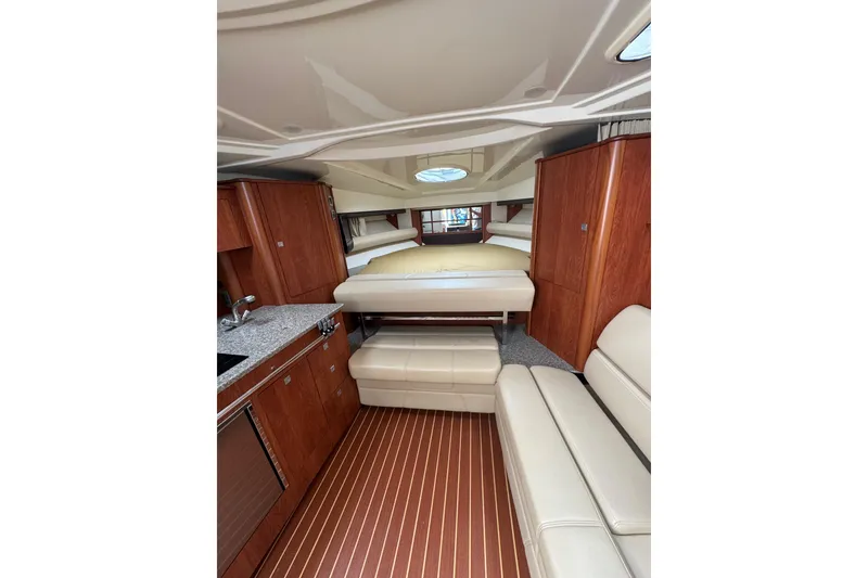 Slide: The Image of Interior cabin of 2009 Monterey 320 Sport Yacht with beige seating and bedding. - 44