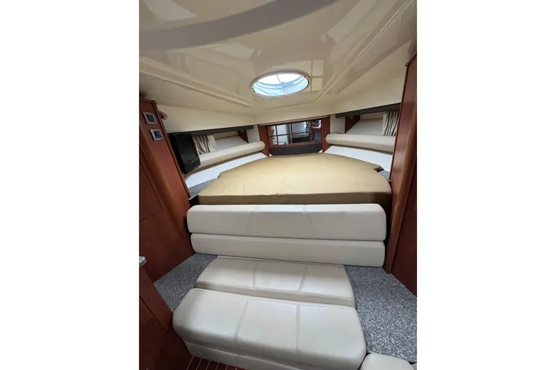 Slide: The Image of 2009 Monterey 320 Sport Yacht interior with kitchenette, wood cabinetry, and seating area. - 47