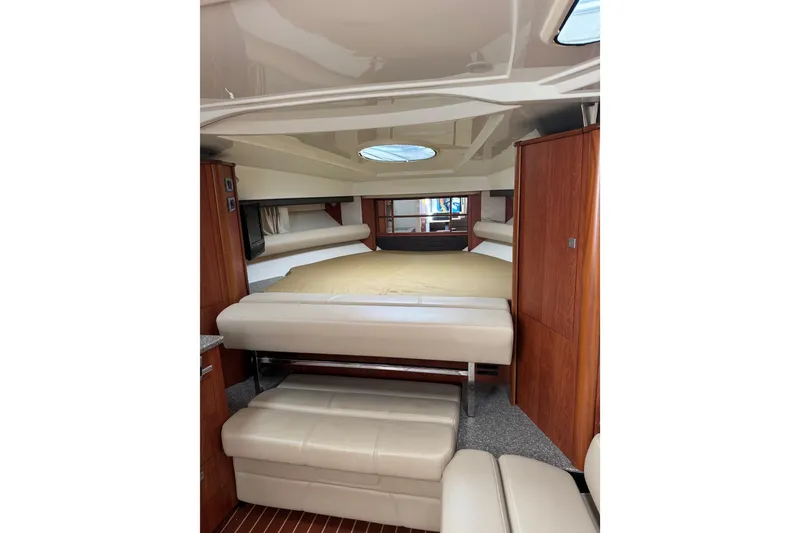 Slide: The Image of 2009 Monterey 320 Sport Yacht interior kitchen with microwave, stove, and wooden cabinetry. - 48