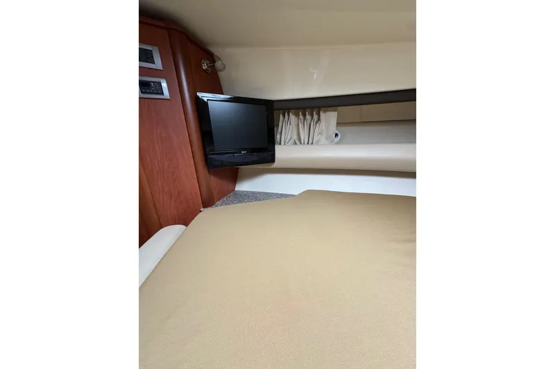 Slide: The Image of 2009 Monterey 320 Sport Yacht kitchen with wood cabinetry and modern appliances. - 49