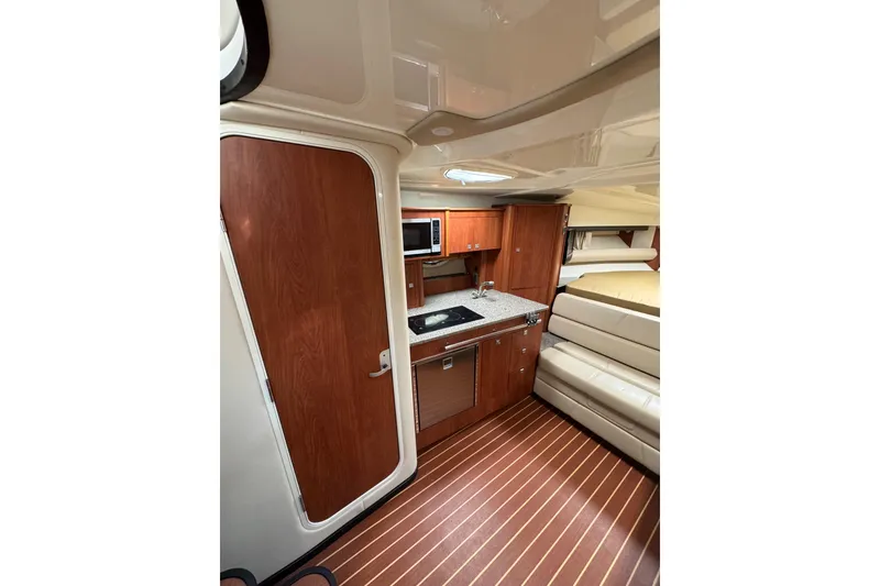 Slide: The Image of Microwave in 2009 Monterey 320 Sport Yacht kitchen, open door, wood cabinetry. - 50