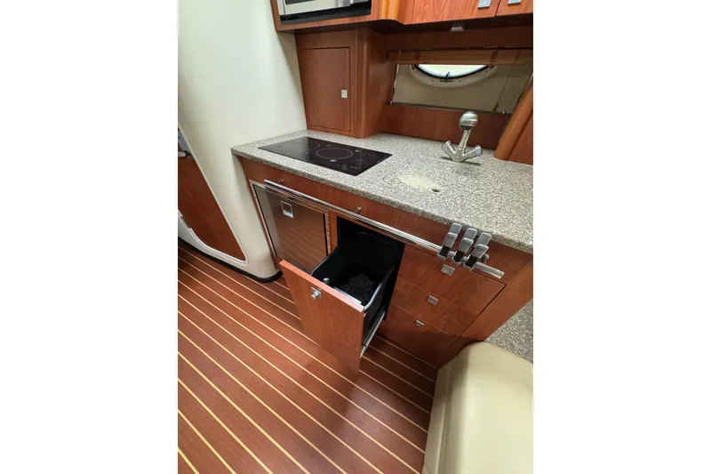 Slide: The Image of Open refrigerator in 2009 Monterey 320 Sport Yacht kitchen with wooden cabinetry. - 52