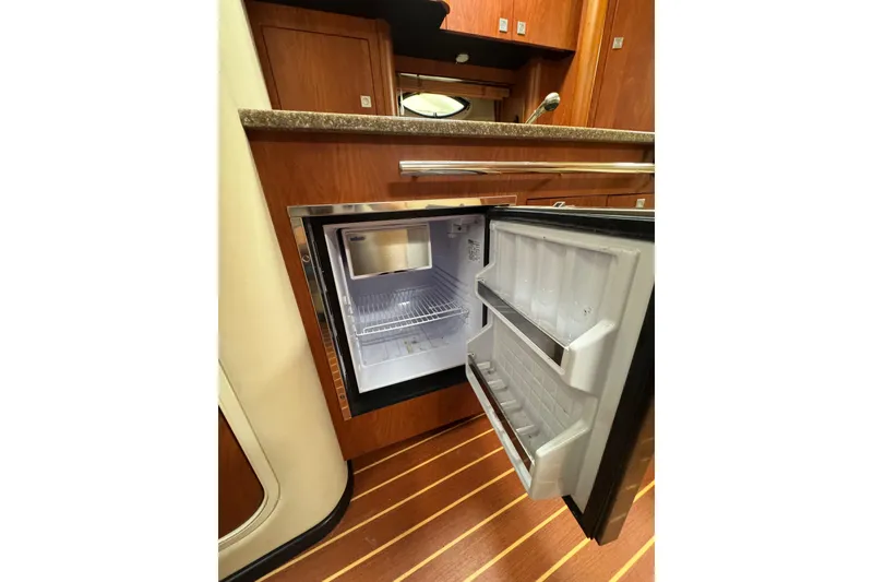 Slide: The Image of Interior of 2009 Monterey 320 Sport Yacht with TV and wooden cabinetry. - 55
