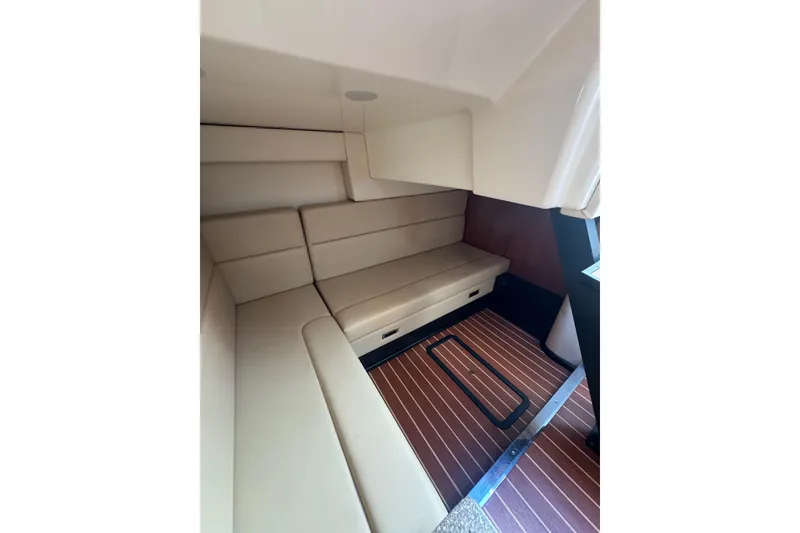 Slide: The Image of 2009 Monterey 320 Sport Yacht, white exterior, docked between covered boats. - 59
