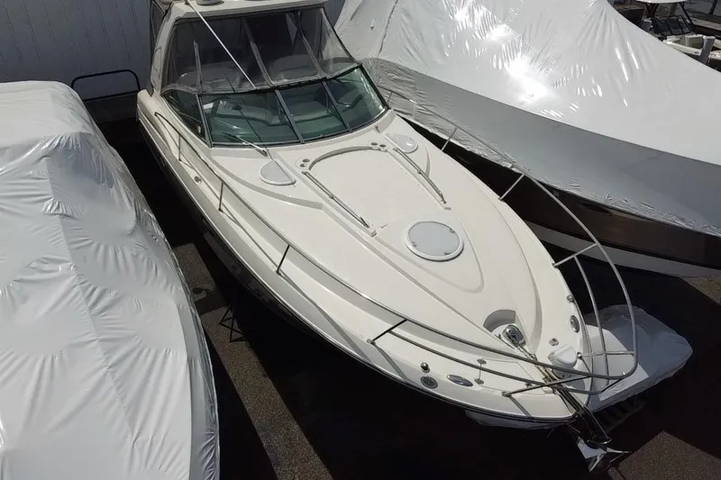 Slide: The Image of Aerial view of 2009 Monterey 320 Sport Yacht between two covered boats. - 7