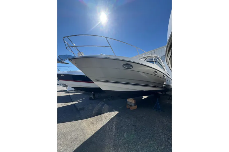 Slide: The Image of 2009 Monterey 320 Sport Yacht under bright sun, displayed on stands. - 8