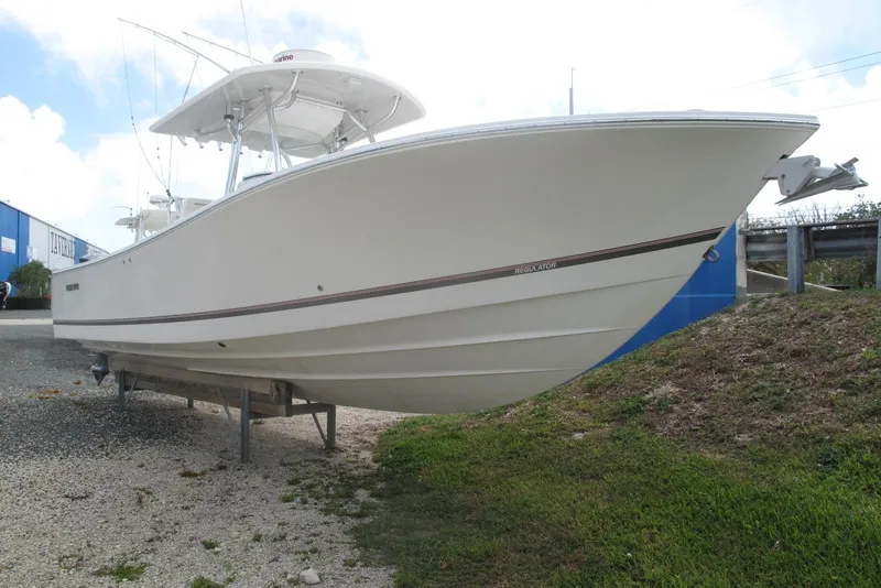 The Image of 2013 Regulator 32 Forward Seating boat on trailer, side view. - 0