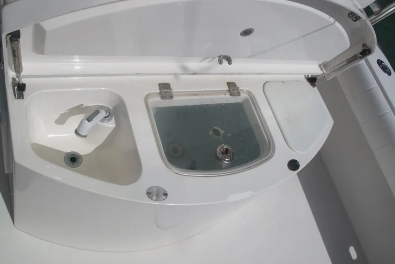 Slide: The Image of 2013 Regulator 32 Forward Seating boat sink and storage compartments. - 14