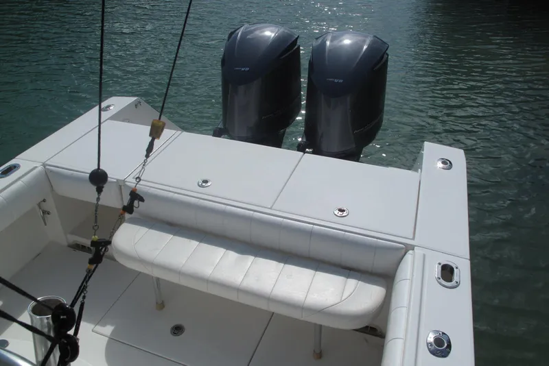 Slide: The Image of 2013 Regulator 32 Forward Seating boat with twin outboard engines on calm water. - 15
