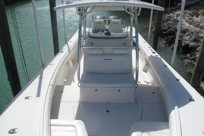Slide: The Image of 2013 Regulator 32 Forward Seating boat with sleek white interior and spacious deck. - 16