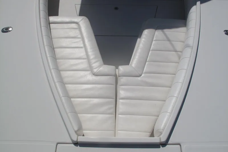 Slide: The Image of 2013 Regulator 32 Forward Seating boat with white cushioned seats. - 17