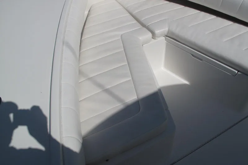 Slide: The Image of 2013 Regulator 32 Forward Seating boat with white cushioned seats. - 18