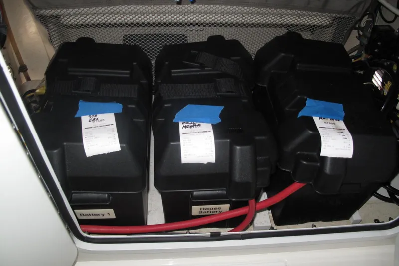 Slide: The Image of Battery compartment of a 2013 Regulator 32 Forward Seating boat, featuring three labeled batteries. - 19