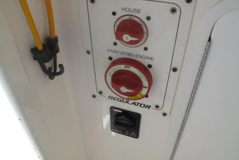 Slide: The Image of Control panel of a 2013 Regulator 32 Forward Seating boat with engine switches. - 21