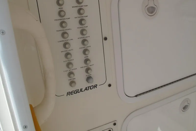 Slide: The Image of Control panel of a 2013 Regulator 32 Forward Seating boat with labeled switches. - 22