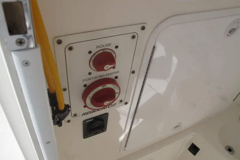 Slide: The Image of Control panel on a 2013 Regulator 32 Forward Seating boat, featuring engine switches. - 23