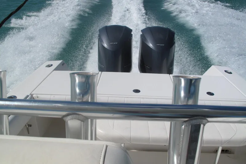 Slide: The Image of 2013 Regulator 32 Forward Seating boat with dual engines cruising on water. - 25