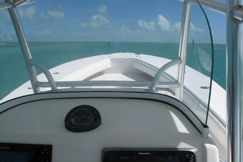 Slide: The Image of 2013 Regulator 32 Forward Seating boat navigating clear blue waters. - 26