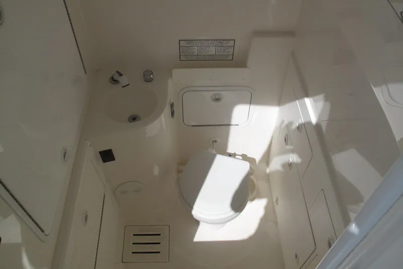 Slide: The Image of 2013 Regulator 32 Forward Seating boat bathroom interior with sink and toilet. - 27
