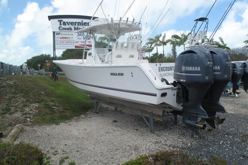Slide: The Image of 2013 Regulator 32 Forward Seating boat with Yamaha engines at marina. - 28