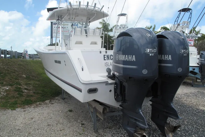 Slide: The Image of 2013 Regulator 32 Forward Seating boat with twin Yamaha 350 engines displayed outdoors. - 29