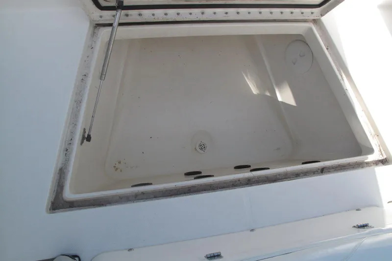 Slide: The Image of Open storage compartment on a 2013 Regulator 32 Forward Seating boat. - 3