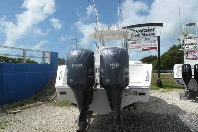 Slide: The Image of 2013 Regulator 32 Forward Seating boat with twin Yamaha 350 engines at marina. - 30