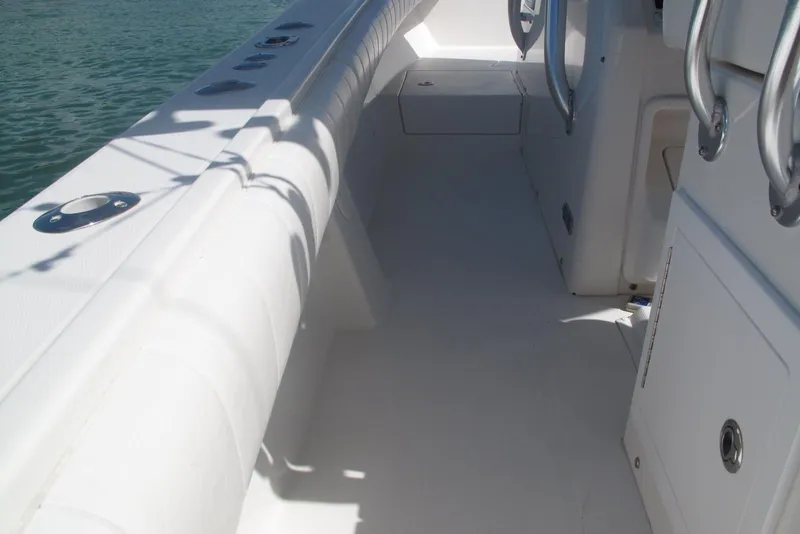 Slide: The Image of 2013 Regulator 32 Forward Seating boat interior with white seating and stainless steel fixtures. - 33