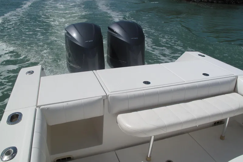 Slide: The Image of 2013 Regulator 32 Forward Seating boat with twin outboard motors on water. - 37