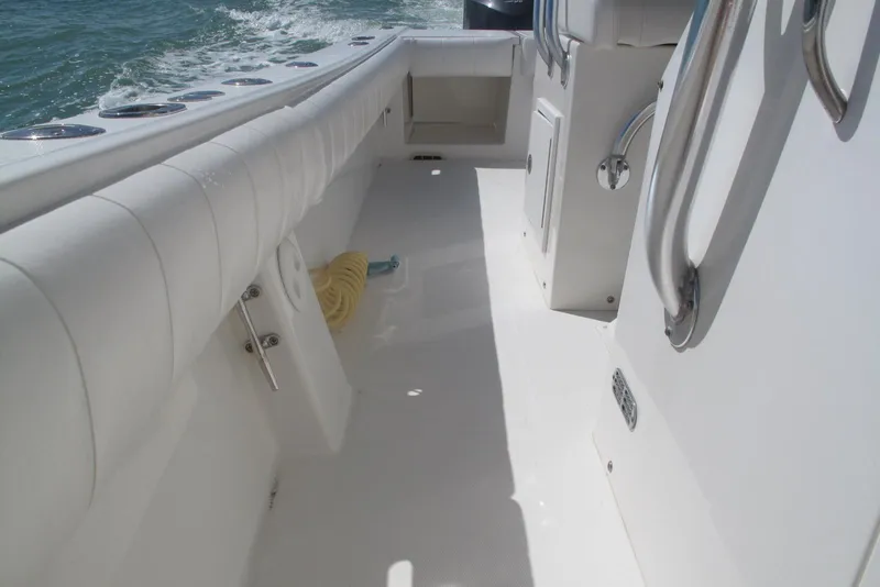 Slide: The Image of 2013 Regulator 32 Forward Seating boat interior with white upholstery and stainless steel fixtures. - 39