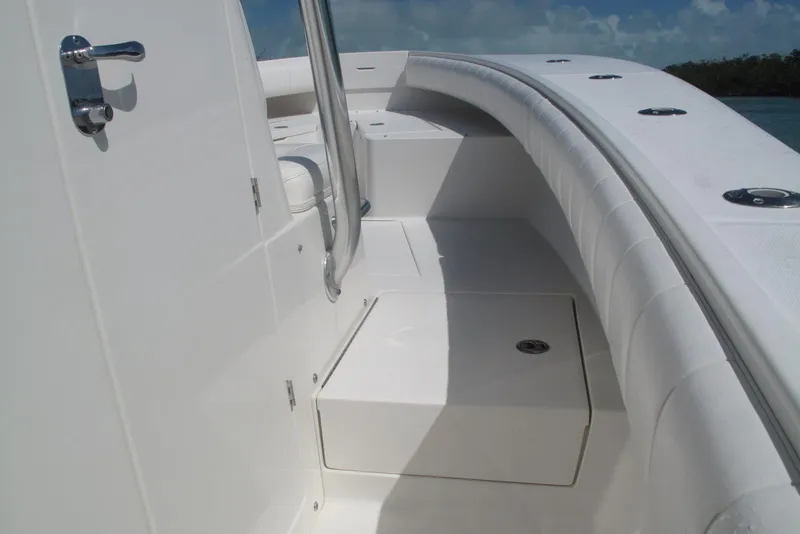 Slide: The Image of 2013 Regulator 32 Forward Seating boat interior with white upholstery and stainless steel fixtures. - 40