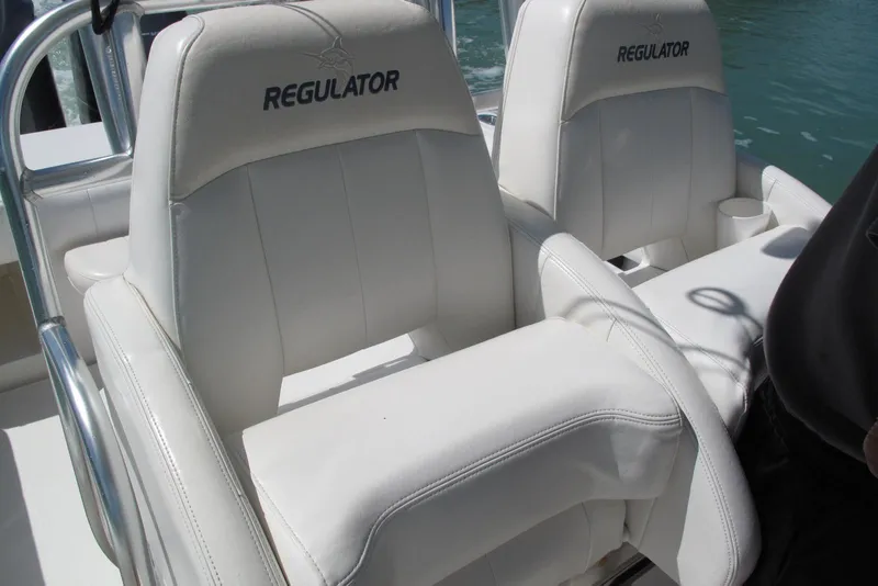 Slide: The Image of 2013 Regulator 32 Forward Seating boat with white cushioned seats. - 41
