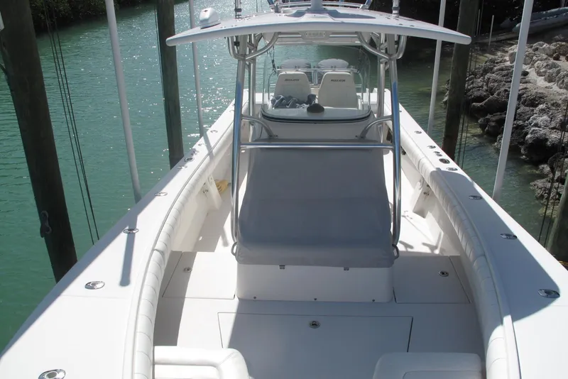 Slide: The Image of 2013 Regulator 32 Forward Seating boat docked in clear water. - 5