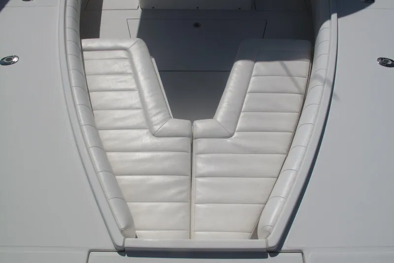 Slide: The Image of 2013 Regulator 32 Forward Seating boat with white cushioned seats. - 6