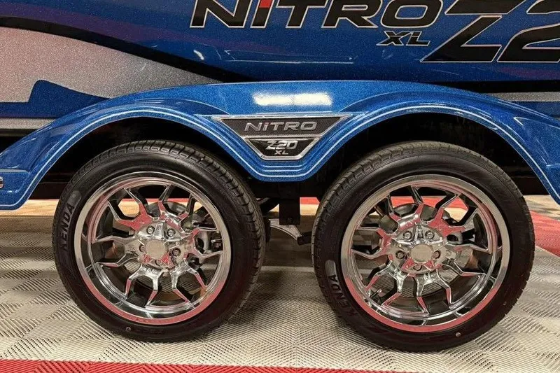 Slide: The Image of 2026 Nitro Z20 XL Pro trailer with shiny chrome wheels and blue fender detailing. - 10