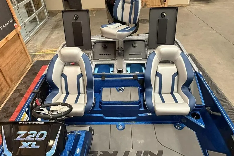 Slide: The Image of 2026 Nitro Z20 XL Pro boat interior with blue and gray seating, steering wheel, and storage compartments. - 12