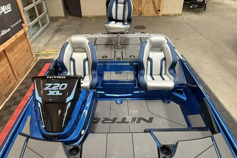 Slide: The Image of 2026 Nitro Z20 XL Pro boat interior with blue and gray seating in a showroom. - 14