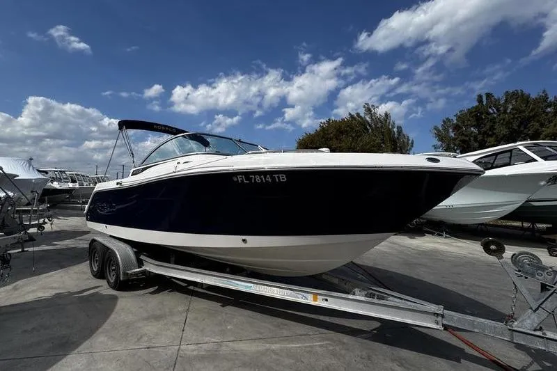 The Image of 2021 Robalo R227 Dual Console boat on trailer under blue sky. - 1