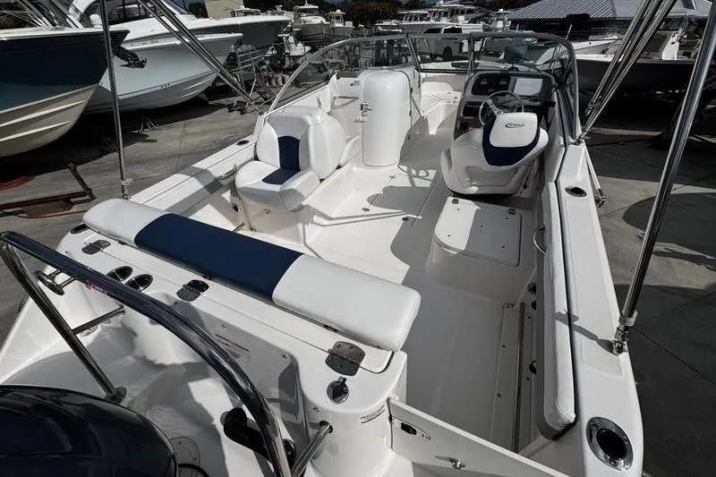 Slide: The Image of 2021 Robalo R227 Dual Console boat interior with seating and steering console. - 12