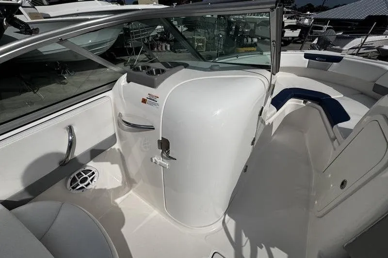 Slide: The Image of 2021 Robalo R227 Dual Console boat interior with seating and storage compartments. - 13