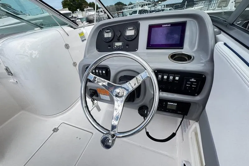 Slide: The Image of 2021 Robalo R227 Dual Console boat dashboard with steering wheel and navigation display. - 17