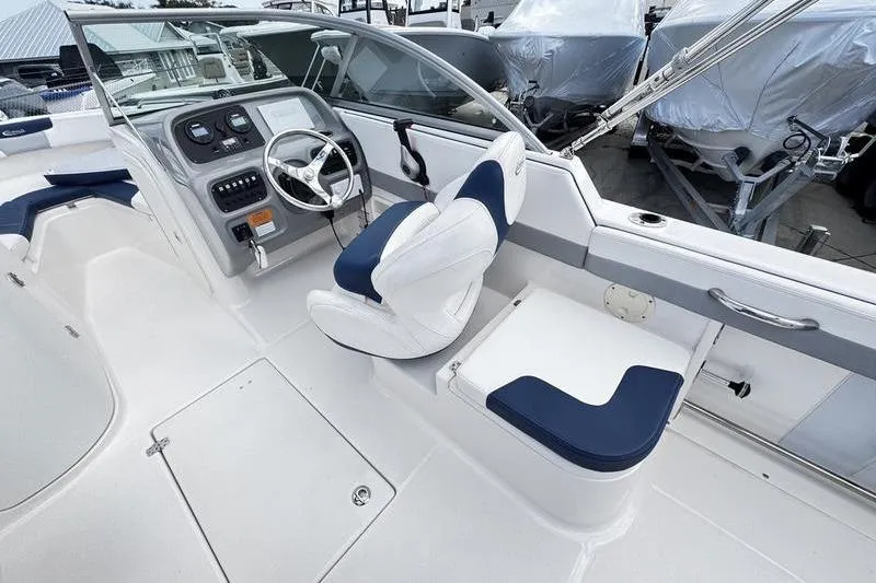 Slide: The Image of 2021 Robalo R227 Dual Console boat interior with steering wheel and seating. - 19