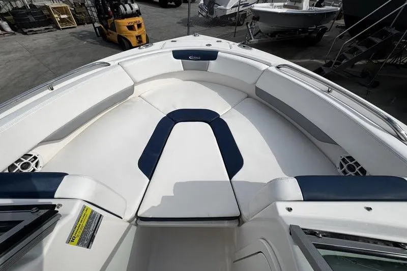 Slide: The Image of 2021 Robalo R227 Dual Console boat interior with white and navy seating. - 9