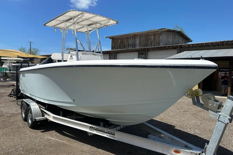 The Image of 2023 LFG 22CC boat on trailer, parked outdoors under clear blue sky. - 1