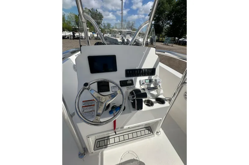 Slide: The Image of 2023 LFG 22CC boat console with steering wheel, controls, and navigation display. - 10