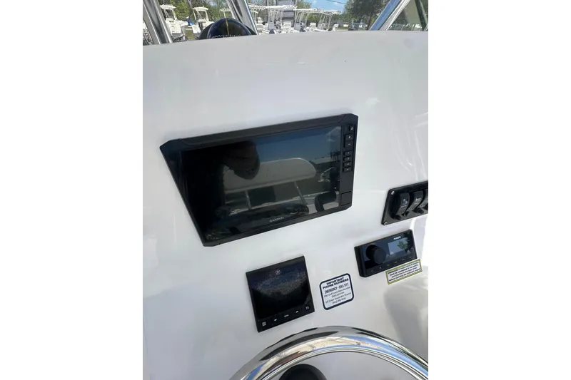 Slide: The Image of Control panel of 2023 LFG 22CC boat with navigation and control screens. - 11